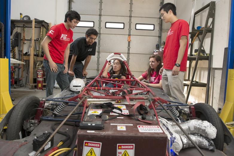 Five students collaborating on a solar electric vehicle.