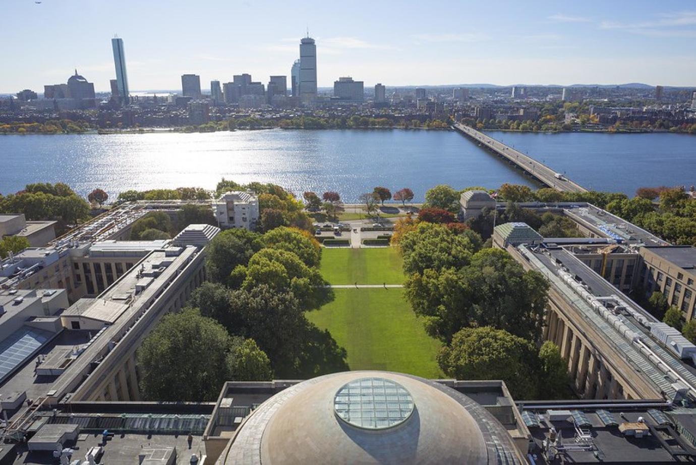 Aerial view of the MIT Dome with the Charles, River and Boston skyline in the distance.