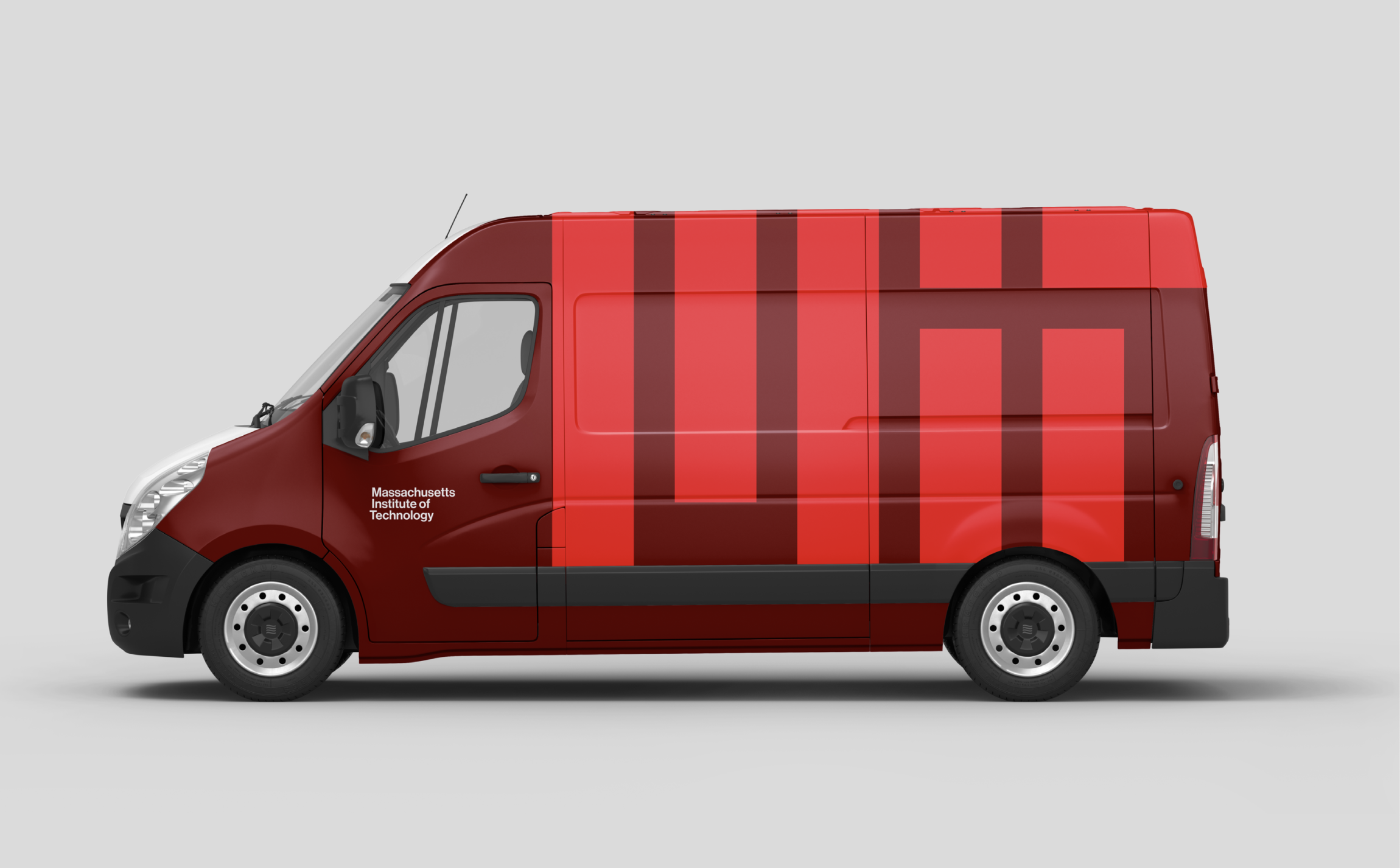 Conceptual design of an MIT Facilities van. The van is shown in MIT red, with a large bright red MIT logo and Massachusetts Institute of Technology in smaller white text.